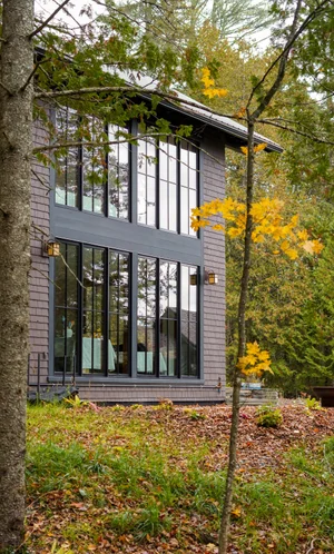 Gunther Accessory Dwelling — Two-story window wall through the pines