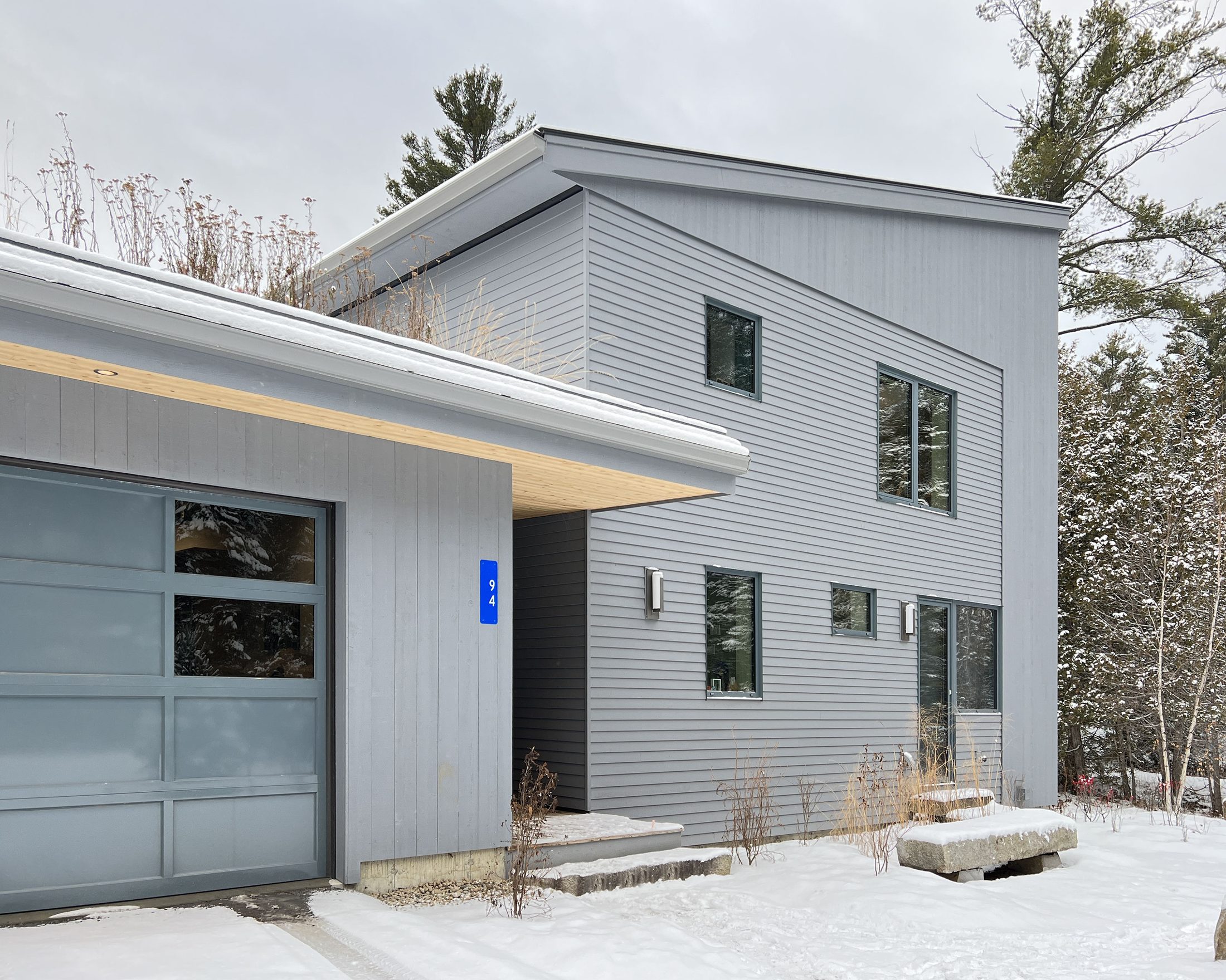 Steel Residence — Entry and glazed garage door